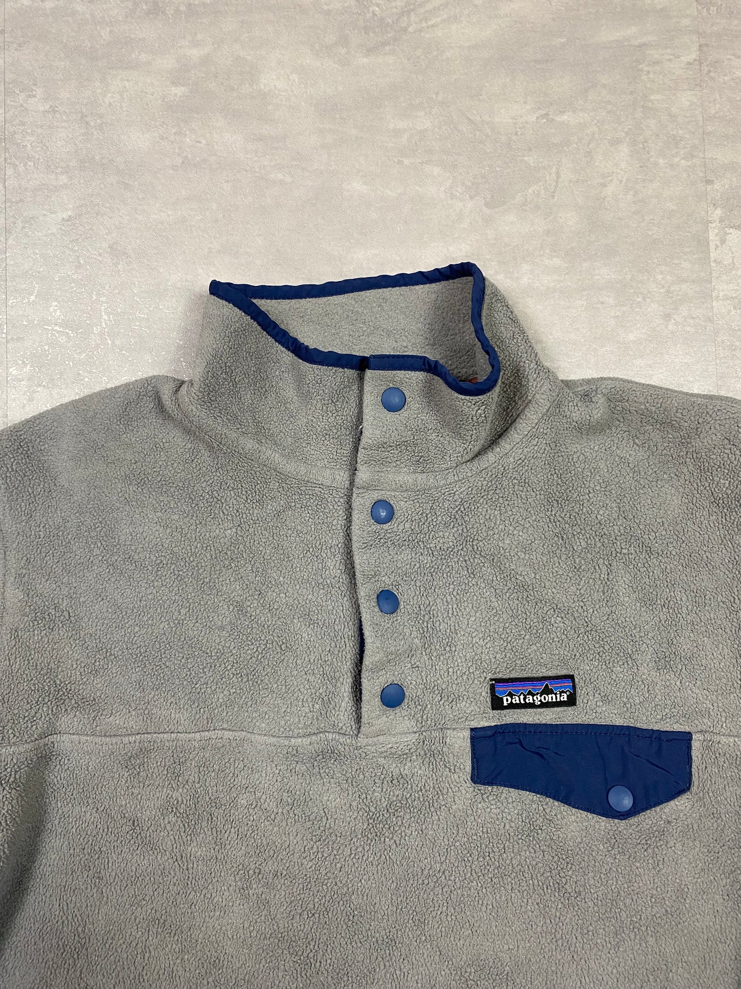 Patagonia fleece front pocket with bottons