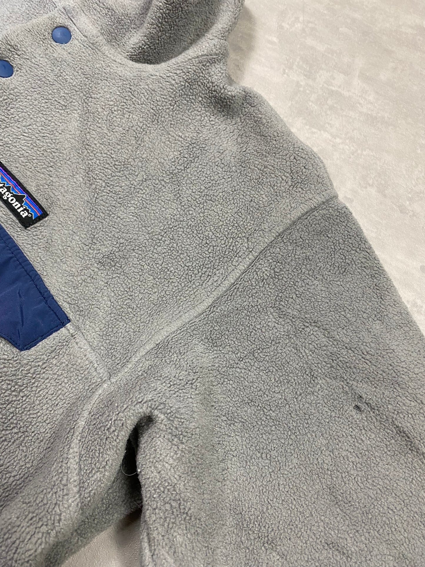 Patagonia fleece front pocket with bottons