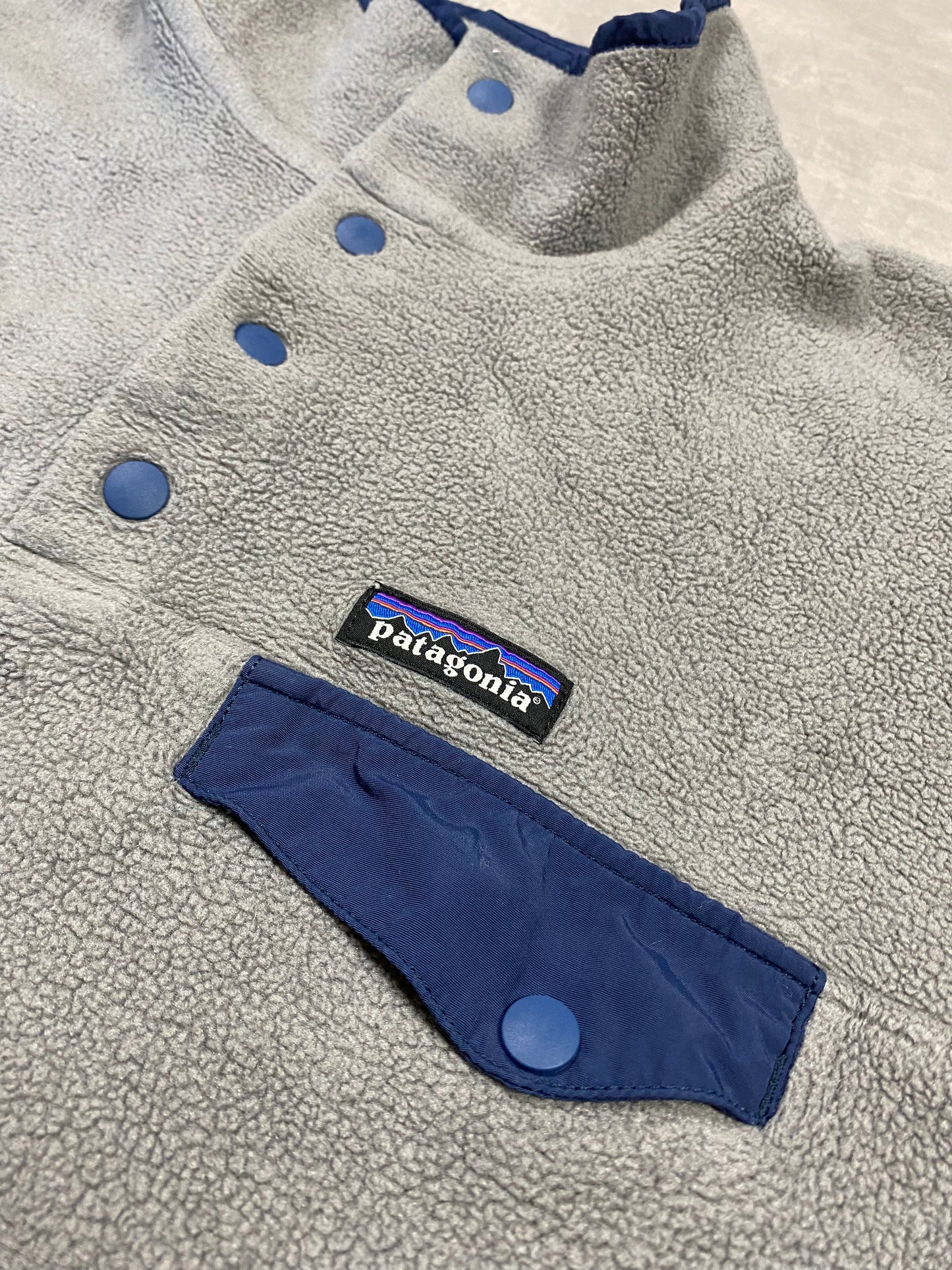 Patagonia fleece front pocket with bottons